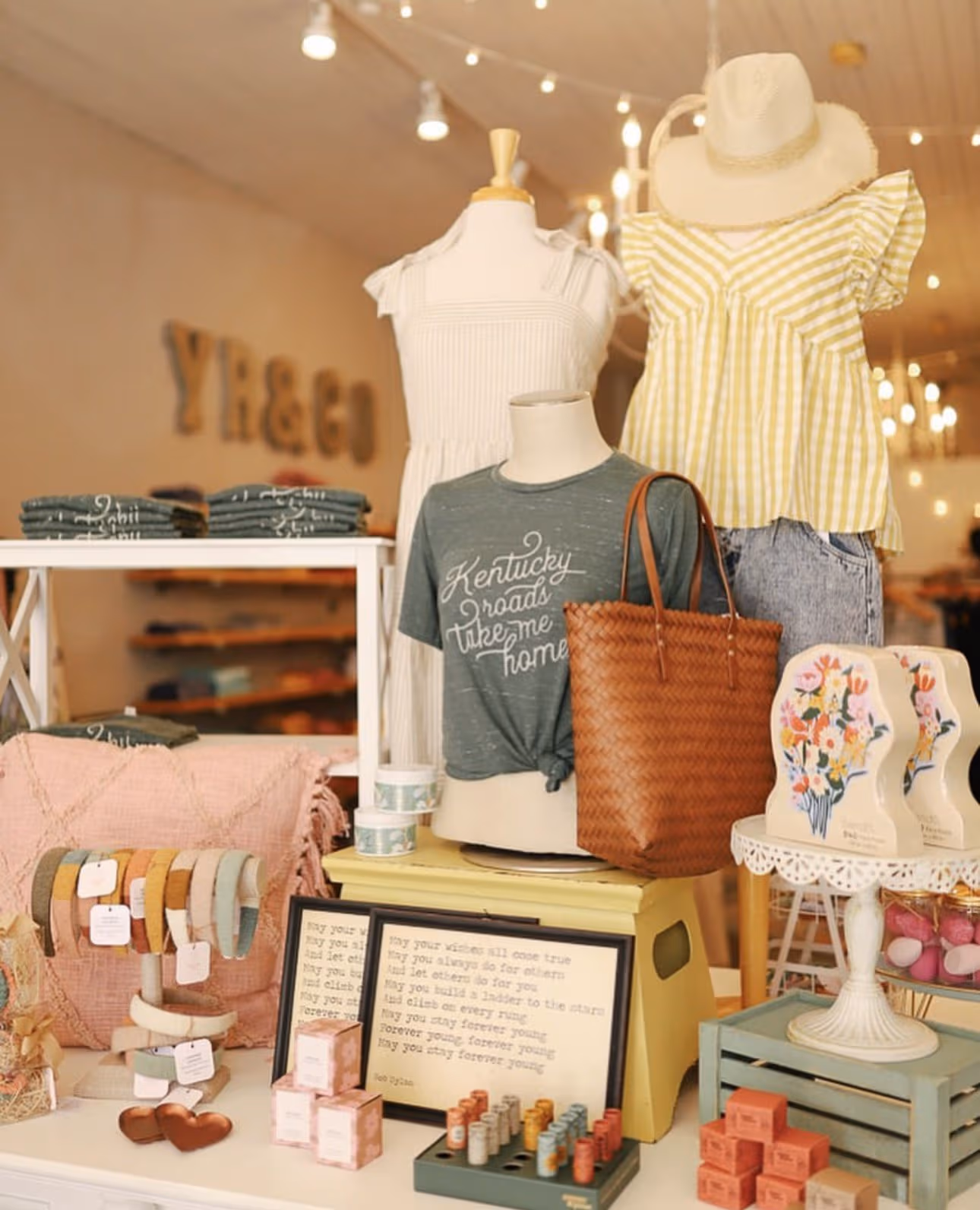 Cozy small-town Kentucky boutique interior, the Y & Co shop, with handmade goods, vintage signs, and warm string lights